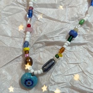 Beaded necklace with tye dye bead charm